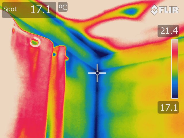 Thermal image of a wall and ceiling taken using a Rainbow colour palette. The blue on the walls indicates inadequate insulation and/or damp. 
