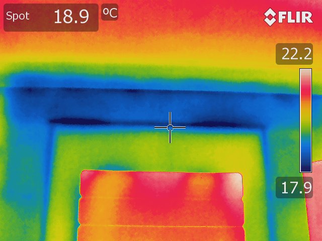 Thermal image of a wall taken using a Rainbow colour palette. The blue spots indicate damp or areas susceptible to damp.