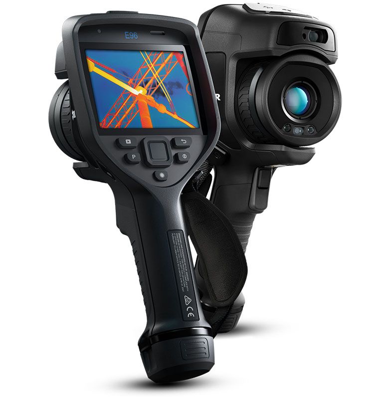 Two FLIR E96 Thermal Cameras. The camera in the foreground is slightly angled and facing backwards, on its display there is a thermal image of a power grid. The camera in the background is also angled but facing forwards. 