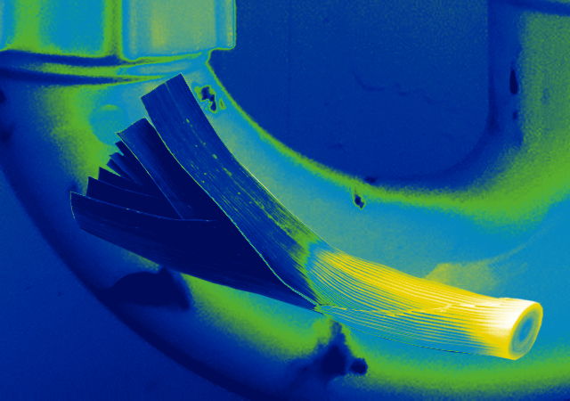 Blue and green thermal image of a leek (vegetable) in a pipe. 