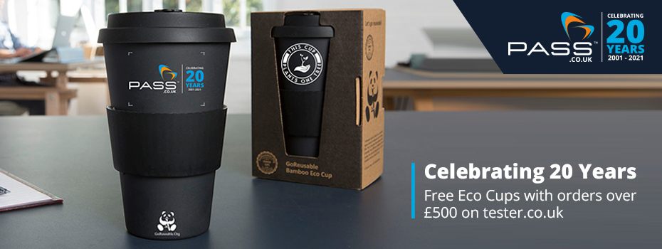 2 black GoReusable Bamboo coffee cups are stood on a table in an office. One cup is unboxed and features the PASS Ltd 20 Years Logo; the other is boxed and includes the  GoReusable logo. The text in the bottom-right of the image reads 'Celebrating 20 years Free Eco Cups with orders over £500 on tester.co.uk'. The PASS Ltd 20 Years logo is in the top-right corner of the image.  