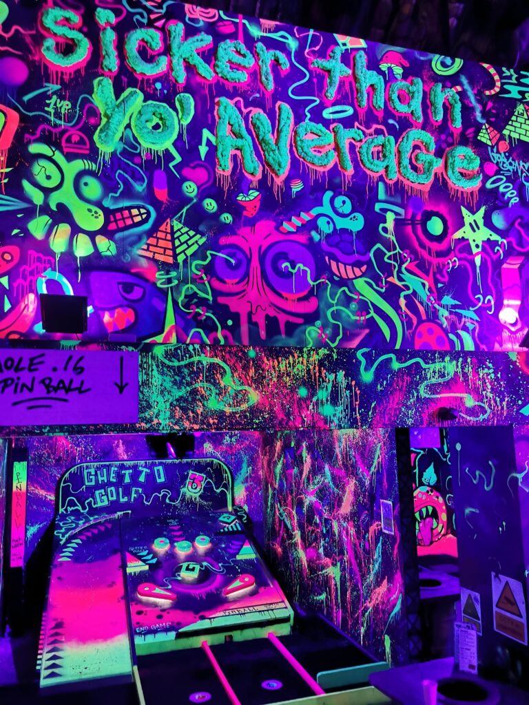 A wall covered in glow-in-the-dark graffiti. 