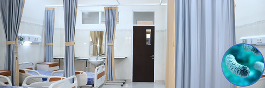 A hospital room lined with beds on the left and a drawn curtain on the right. In the bottom right of the image is a blue legionella bacteria in a circle. 
