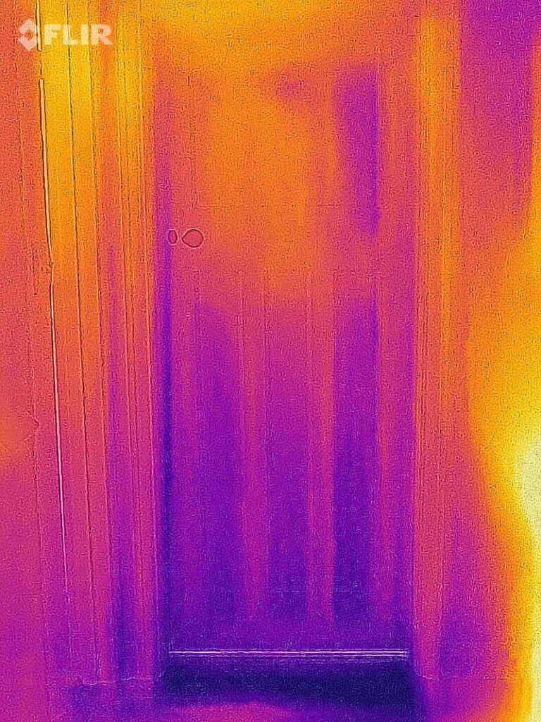 Thermal image of an unused, unheated bedroom with the door closed. 