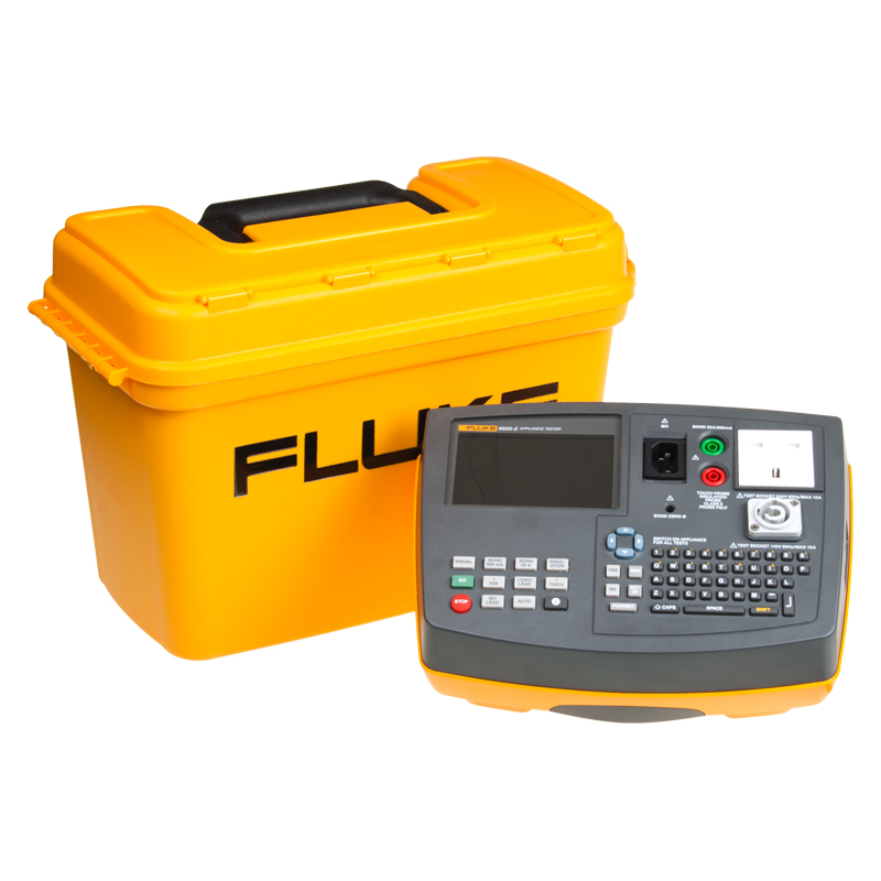 Fluke 6500-2 Downloadable PAT Tester sits in front of a large yellow carry case. 