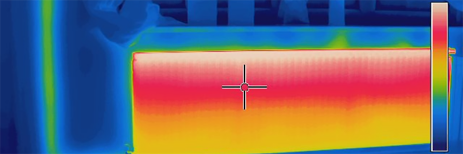Thermal image of a radiator taken using a Rainbow Palette. The top is red and white, indicating it is hotter, and the bottom is yellow, indicating it is colder.