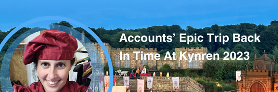 To the right of the image large white text reads "Accounts' Epic Trip Back In Time At Kynren 2023". It sits on a photo background of people in medieval dress holding medieval banners standing in front of a stone castle backed by trees. In the bottom left of the image is a circular photo of a young woman with with dark hair and eyes. She is dressed in a floppy medieval hat and taking a smiley selfie. The selfie is framed by a light blue circular border. 
