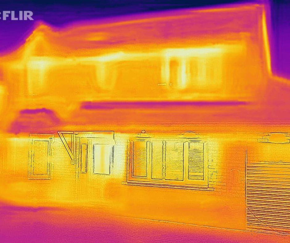 Thermal image of an energy inefficient home. The house is bright yellow. 
