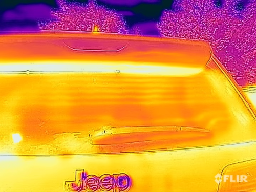 Thermal image of the rear window of a Jeep. The heating grid can be seen. It shows up as yellow lines on the rear window. 