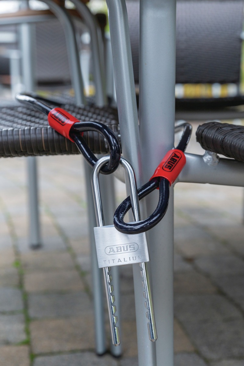 ABUS Titalium 64TI Keyed Padlock locking some chairs togther.