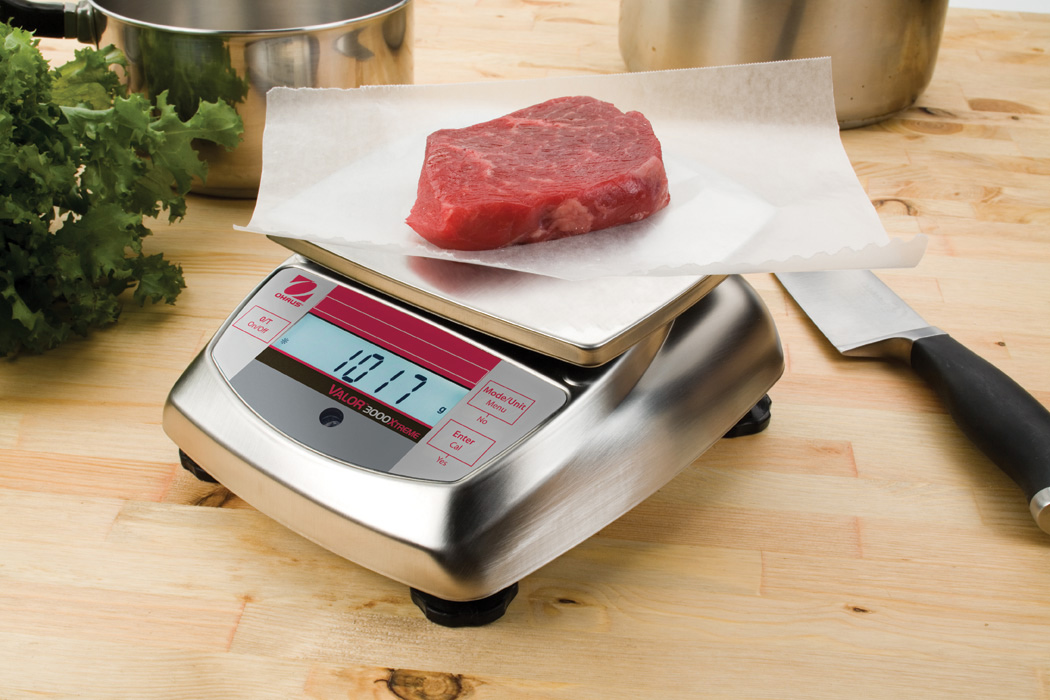 Ohaus Valor 3000 V31 Compact Precision Food Bench Scales weighing some meat.