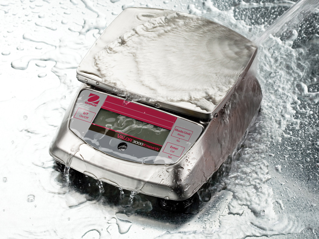 Ohaus Valor 3000 V31 Compact Precision Food Bench Scales with water thrown over its tough, rugged design.