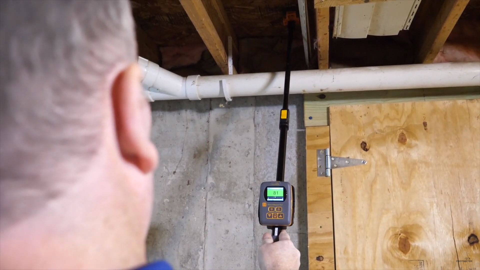 Protimeter ReachMaster Pro Moisture Meter measuring the level of moistre in a ceiling.