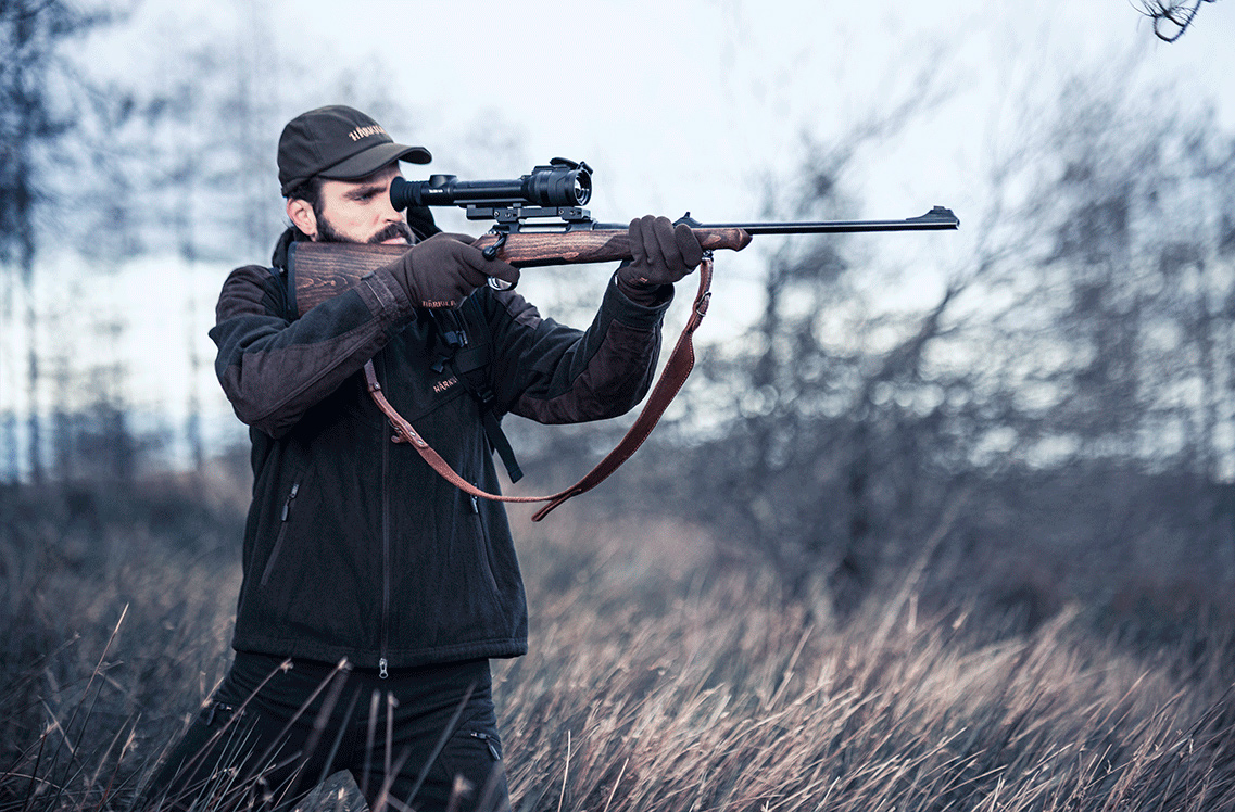 Pulsar Talion XQ35 Pro Riflescope used by a hunter taking aim during the day.