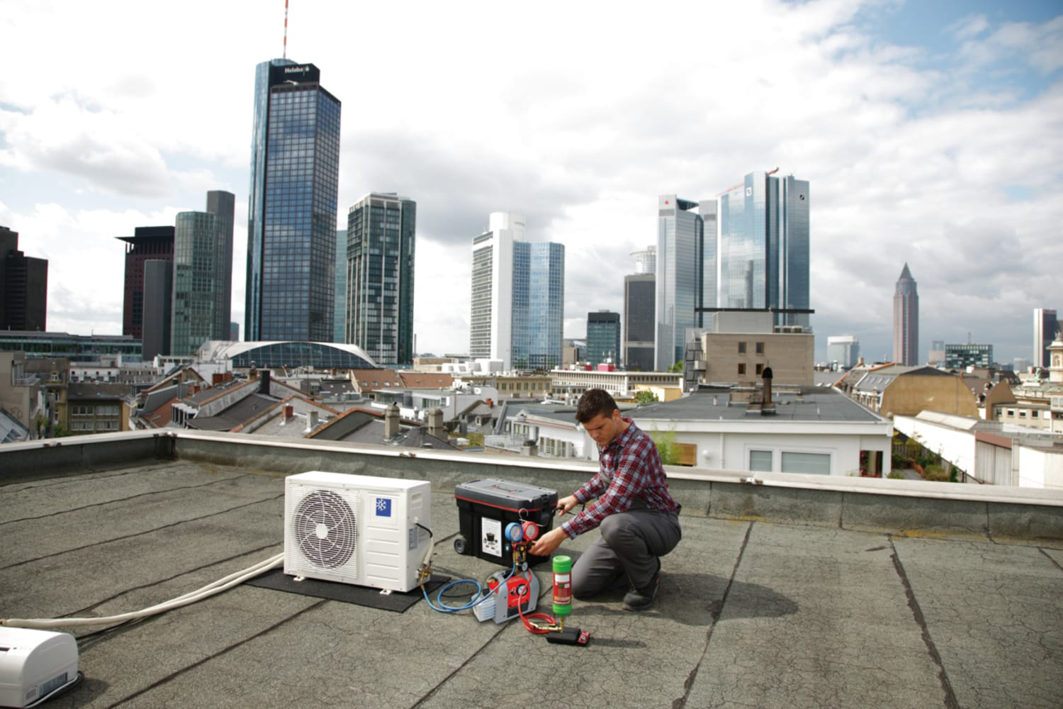 Rothenberger Roairvac Refrigerant Vacuum Pump in action on a rooftop.
