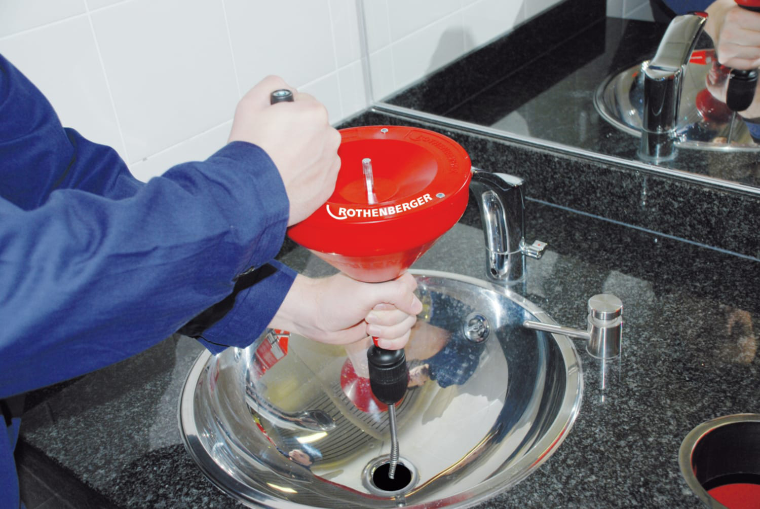 Rothenberger Rospi H&E Plus Drain Cleaner with Spiral being used in a sink.